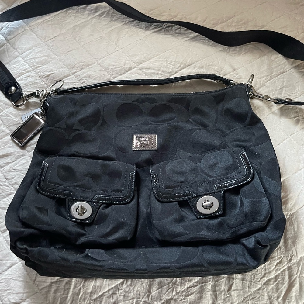 Black with pink interior Coach crossbody or handle purse.